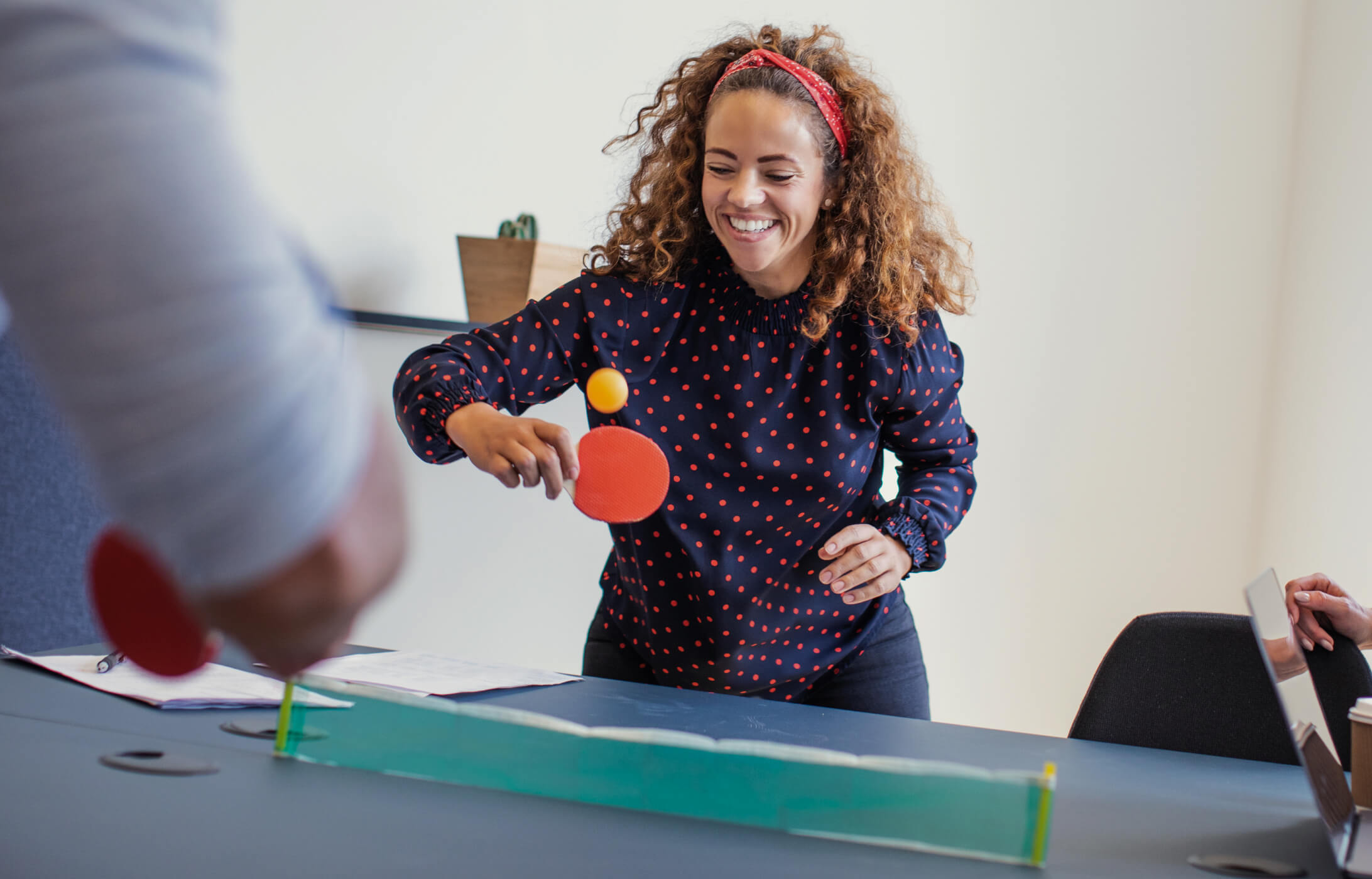 laughing-coworkers-playing-table-tennis